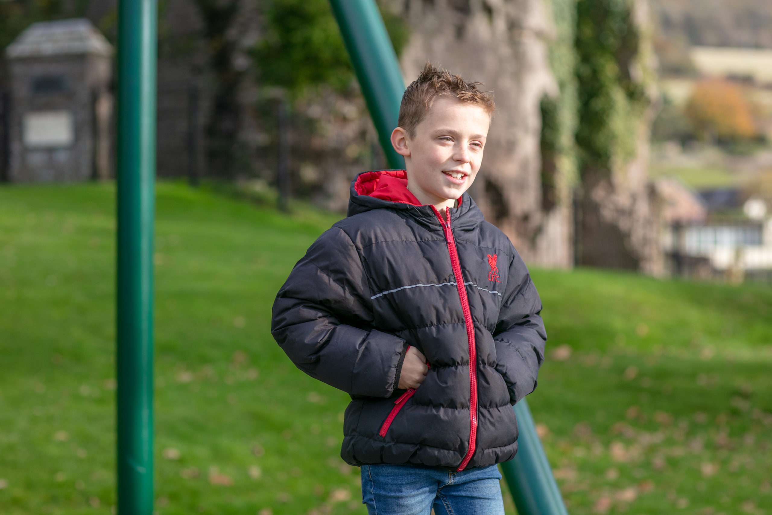 young boy standing and smiling