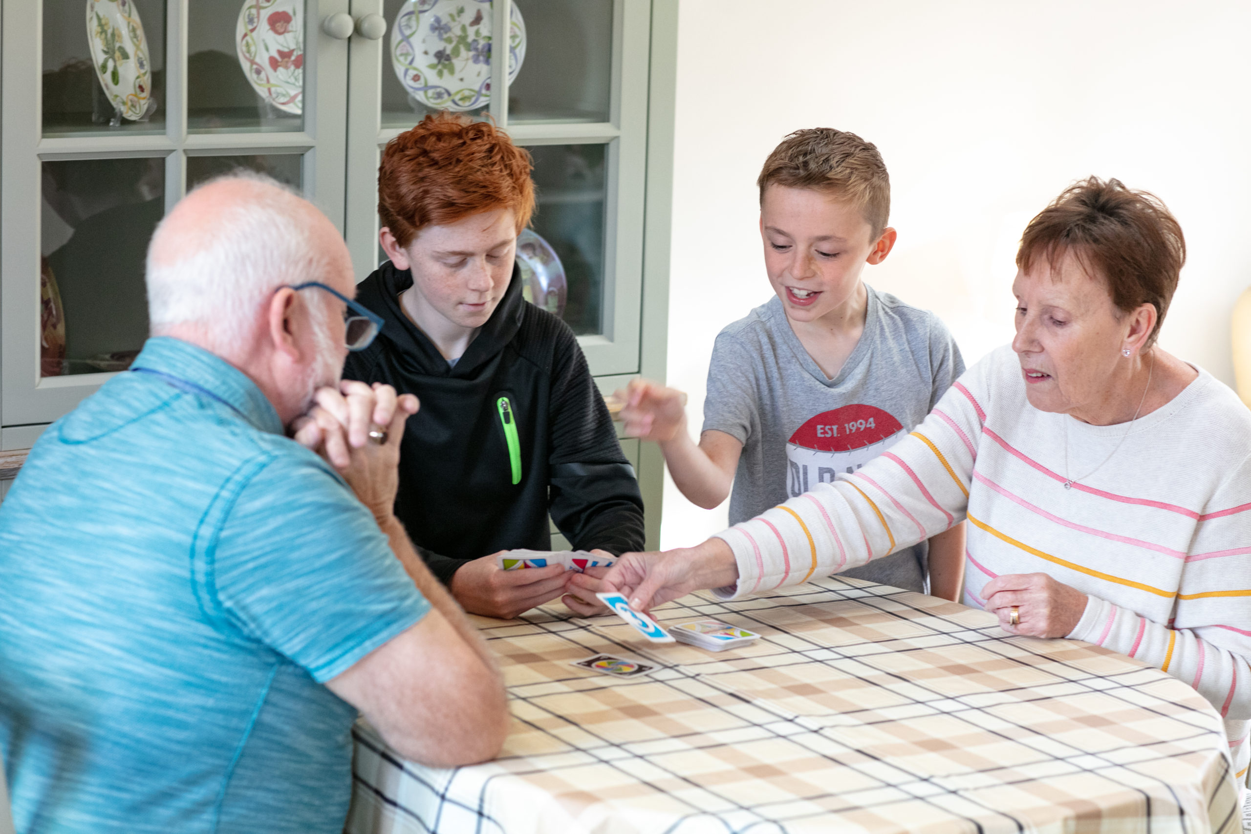 family sitting around a table playing games
